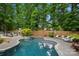 Inviting backyard pool with a spa, lounge chairs, and a covered outdoor kitchen, perfect for entertaining at 19507 Dufour Ct, Cornelius, NC 28031