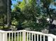 Private backyard with potted flowers along the deck railing and mature trees at 20107 N Cove Rd, Cornelius, NC 28031