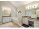 Bright bathroom with vaulted ceilings, double sinks, granite countertops, and soaking tub at 20107 N Cove Rd, Cornelius, NC 28031