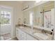Bathroom featuring dual vanities with granite counters and a large mirror at 20107 N Cove Rd, Cornelius, NC 28031