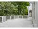 Expansive deck with white railings overlooking a lush, tree-filled backyard, creating a peaceful atmosphere at 20107 N Cove Rd, Cornelius, NC 28031