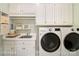 Functional laundry room with washer, dryer, sink, and ample storage space at 20107 N Cove Rd, Cornelius, NC 28031