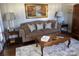 Cozy living room featuring a plush sofa, decorative pillows, and a shag rug at 20107 N Cove Rd, Cornelius, NC 28031