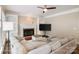 Spacious living room with fireplace, ceiling fan, and neutral tones offers a cozy, inviting atmosphere at 20107 N Cove Rd, Cornelius, NC 28031