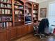 Home office with custom built-in bookshelves and hardwood floors at 20107 N Cove Rd, Cornelius, NC 28031