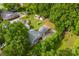 Aerial view of the house with a large backyard, patio area, and mature trees at 204 S Elm St, Cherryville, NC 28021