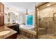 Well-appointed bathroom featuring tiled floor and walls, soaking tub and glass enclosed shower at 204 S Elm St, Cherryville, NC 28021