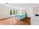 Bright bedroom with hardwood floors, sun-filled windows and light blue bedding at 204 S Elm St, Cherryville, NC 28021