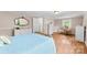 Sunny bedroom with hardwood floors, white dressers and comfortable light blue bedding at 204 S Elm St, Cherryville, NC 28021