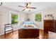 Cozy bedroom with hardwood floors, ceiling fan and sun-filled windows at 204 S Elm St, Cherryville, NC 28021
