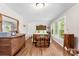 Sunlit bedroom with hardwood floors, dresser, decorative chest, and bright windows at 204 S Elm St, Cherryville, NC 28021