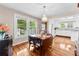 Dining room with hardwood floors, chandelier, and view into the adjacent kitchen at 204 S Elm St, Cherryville, NC 28021