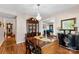 Dining room featuring a chandelier, wood table, and a view into the adjacent living room at 204 S Elm St, Cherryville, NC 28021