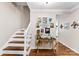 Charming hallway with staircase, hardwood floors and decorative console table at 204 S Elm St, Cherryville, NC 28021