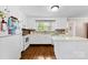 Bright white kitchen featuring a center island, wood floors, and ample cabinet space at 204 S Elm St, Cherryville, NC 28021