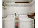 Functional laundry room with washer, dryer, shelves and overhead storage at 204 S Elm St, Cherryville, NC 28021