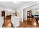 Open-concept living room with hardwood floors, decorative chandelier, and island with marble countertop at 204 S Elm St, Cherryville, NC 28021
