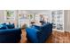 Cozy living room featuring a fireplace, hardwood floors, and comfortable blue furnishings at 204 S Elm St, Cherryville, NC 28021
