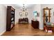 Bright office with hardwood floors, built-in bookshelf, desk and decorative chandelier at 204 S Elm St, Cherryville, NC 28021