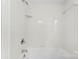 All white, tiled shower with shower head, faucet and shelf at 204 S Elm St, Cherryville, NC 28021
