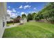 Spacious backyard with lush green grass, storage shed, and basketball hoop for outdoor enjoyment at 2117 Seabrook Ln, Fort Mill, SC 29715