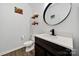 Bathroom with a dark vanity, white countertop and walls, with decorative shelving and decor at 2117 Seabrook Ln, Fort Mill, SC 29715