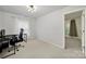 Bedroom with neutral carpet and walls, window, simple lighting, with access to another room at 2117 Seabrook Ln, Fort Mill, SC 29715