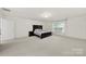 Large bedroom featuring neutral carpet, a queen bed, and a window providing natural light at 2117 Seabrook Ln, Fort Mill, SC 29715