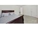 Well-lit bedroom featuring neutral carpet, a twin bed, and a door leading to another room at 2117 Seabrook Ln, Fort Mill, SC 29715
