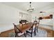 Formal dining room with hardwood floors, classic wainscoting, and an adjacent living area at 2117 Seabrook Ln, Fort Mill, SC 29715