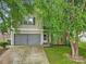 Charming two-story home with a stone facade, well-manicured lawn, and an attached two-car garage at 2117 Seabrook Ln, Fort Mill, SC 29715