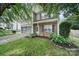Two-story home with a stone facade, manicured lawn, and flowering bushes enhancing curb appeal at 2117 Seabrook Ln, Fort Mill, SC 29715