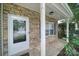 Inviting front porch with stone detailing around a front door with glass and a white pillar at 2117 Seabrook Ln, Fort Mill, SC 29715