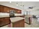 Bright kitchen showcasing wooden cabinetry, an island, stainless steel appliances and tiled flooring at 2117 Seabrook Ln, Fort Mill, SC 29715