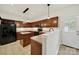 Cozy kitchen featuring wooden cabinetry, an island, stainless steel appliances and access to the outdoors at 2117 Seabrook Ln, Fort Mill, SC 29715