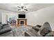 Bright living room with a fireplace, ceiling fan, wood floors, and comfortable seating at 2117 Seabrook Ln, Fort Mill, SC 29715