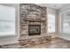 Stone fireplace with windows on either side in a modernly appointed living room at 2232 Tabor Rd # 570, Sherrills Ford, NC 28673