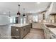 Open kitchen with an island, stainless steel appliances, white cabinetry, and modern backsplash. View of the fireplace at 2232 Tabor Rd # 570, Sherrills Ford, NC 28673
