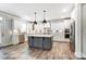 Spacious kitchen featuring white cabinets, gray island, stainless appliances, stylish backsplash, and modern pendant lighting at 2232 Tabor Rd # 570, Sherrills Ford, NC 28673