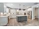 Bright kitchen showcases white cabinets, stainless steel appliances, gray island, modern lighting, and a stylish backsplash at 2232 Tabor Rd # 570, Sherrills Ford, NC 28673