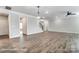 A spacious living room featuring hardwood floors, modern lighting, and staircase access at 2232 Tabor Rd # 570, Sherrills Ford, NC 28673