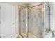 Bathroom featuring a walk-in shower with glass door and tiled walls at 2636 Tillman St, Monroe, NC 28112
