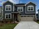Charming two-story home with blue siding, stone accents, and a two-car garage at 2636 Tillman St, Monroe, NC 28112