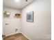 Functional laundry room with stylish wood-look floors, shelving, and modern connections at 2636 Tillman St, Monroe, NC 28112
