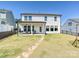 Back of the house with patio and stone walkway overlooking the expansive backyard at 2678 Wedgewood Ct, Denver, NC 28037
