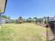 Expansive backyard featuring lush green grass, a playground, and a black iron fence at 2678 Wedgewood Ct, Denver, NC 28037
