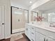 Bathroom featuring a double vanity, white cabinetry, and a glass-enclosed shower at 2678 Wedgewood Ct, Denver, NC 28037