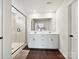 Bright bathroom featuring a double vanity, white cabinetry, and a glass-enclosed shower at 2678 Wedgewood Ct, Denver, NC 28037
