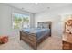 Comfortable bedroom showcasing natural light and a rustic wooden bed frame at 2678 Wedgewood Ct, Denver, NC 28037