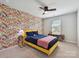 Cheerful bedroom featuring a bold floral accent wall, and a well-lit window at 2678 Wedgewood Ct, Denver, NC 28037